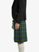 Person wearing a black jacket and blue plaid kilt on a white background