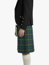 Person wearing a black jacket and blue plaid kilt on a white background