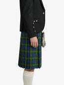 Person wearing a black jacket and green plaid kilt on a white background