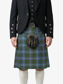 Person wearing a traditional Scottish kilt with a jacket on a white background