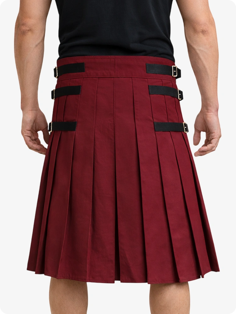 Maroon pleated kilt with black straps on a white background