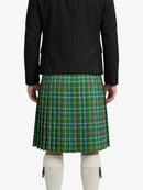 Person wearing a green plaid kilt with a black jacket on a white background