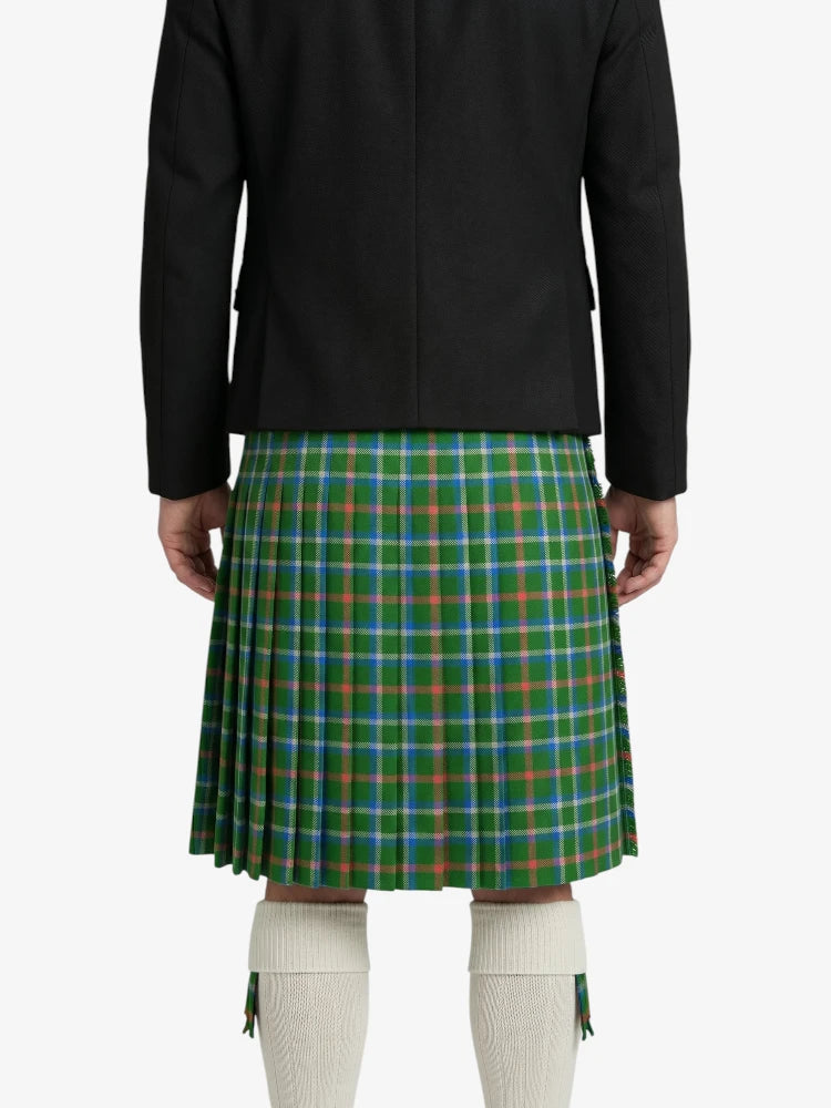 Person wearing a green plaid kilt with a black jacket on a white background