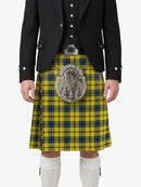 Person wearing a traditional Scottish kilt with a tartan pattern on a white background