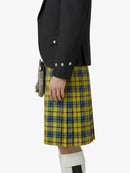 Person wearing a black blazer and yellow plaid kilt on a white background