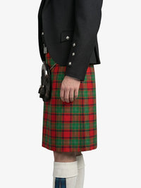 Person wearing a black jacket and red plaid kilt on a white background