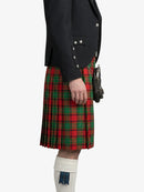 Person wearing a black jacket and red plaid kilt on a white background