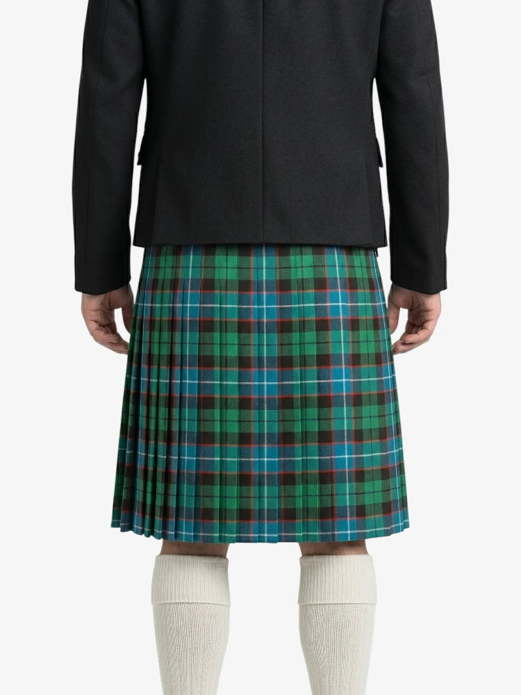 Person wearing a black jacket and green plaid kilt on a white background