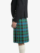 Person wearing a black jacket and green plaid kilt on a white background