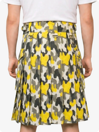 Person wearing a yellow and gray patterned skirt on a white background