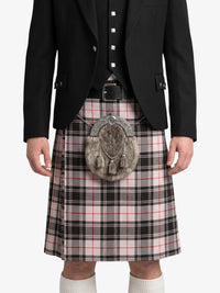 Person wearing a black jacket, plaid kilt, and sporran on a white background
