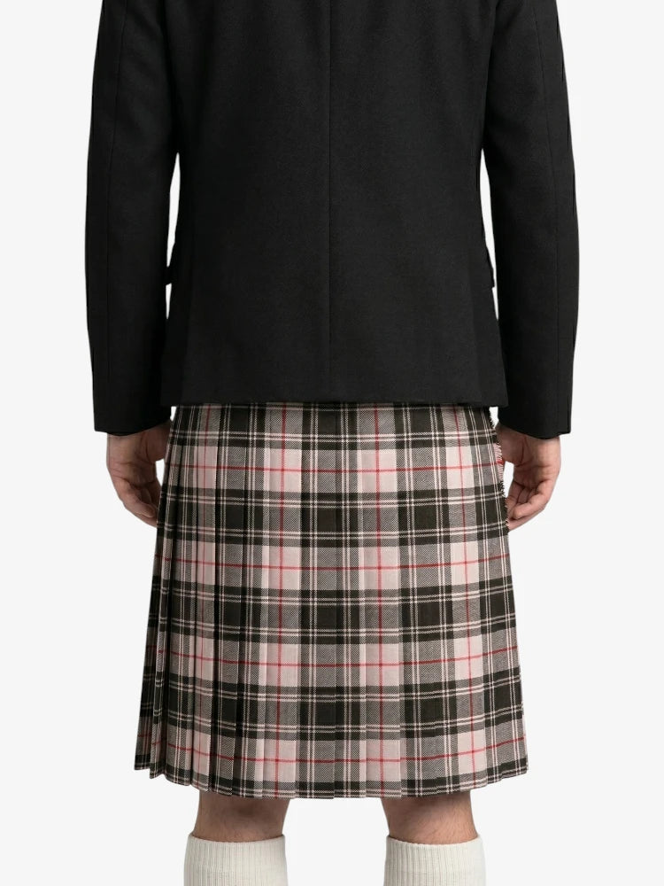 Person wearing a black coat and plaid kilt on a white background