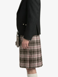Person wearing a black jacket and plaid kilt  on a white background