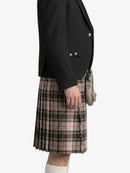 Person wearing a black jacket and plaid kilt on a white background