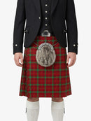 Person wearing a red tartan kilt with a black jacket and white socks on a white background