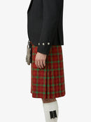 Person wearing a red plaid kilt with a black jacket on a white background