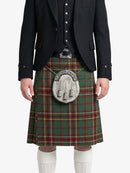 Person wearing a traditional Scottish kilt with a tartan pattern on a white background