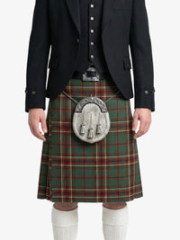 Person wearing a traditional Scottish kilt with a tartan pattern on a white background