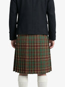 Person wearing a dark coat and green plaid kilt on a white background