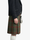Person wearing a dark jacket and plaid kilt on a white background