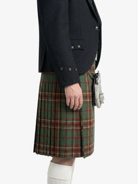 Person wearing a dark jacket and plaid kilt on a white background