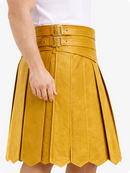 Yellow pleated skirt with a belt on a white background