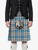 Person wearing a black jacket and blue plaid kilt on a white background
