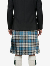 Person wearing a black coat and plaid kilt on a white background