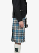Person wearing a black jacket and blue plaid kilt on a white background