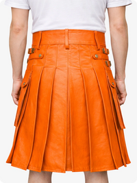 Orange pleated skirt worn by a person on a white background
