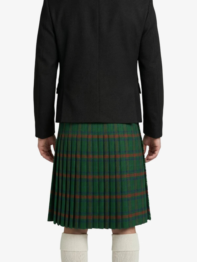 Person wearing a green plaid kilt with a black jacket on a white background