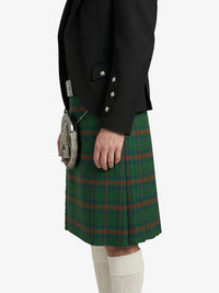 Person wearing a green plaid kilt with a black jacket on a white background