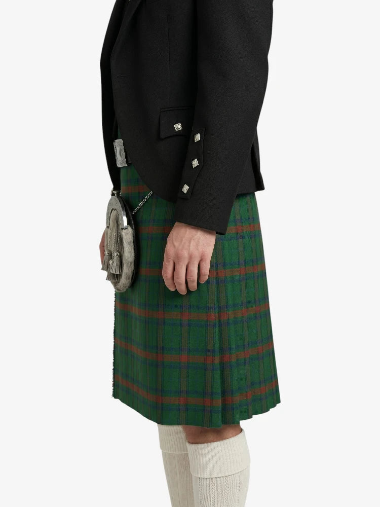 Person wearing a green plaid kilt with a black jacket on a white background