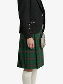 Person wearing a green plaid kilt with a black jacket on a white background