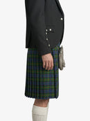 Person wearing a black jacket and green plaid kilt on a white background