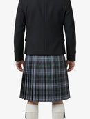 Person wearing a black jacket and plaid kilt on a white background