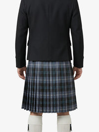Person wearing a black jacket and plaid kilt on a white background