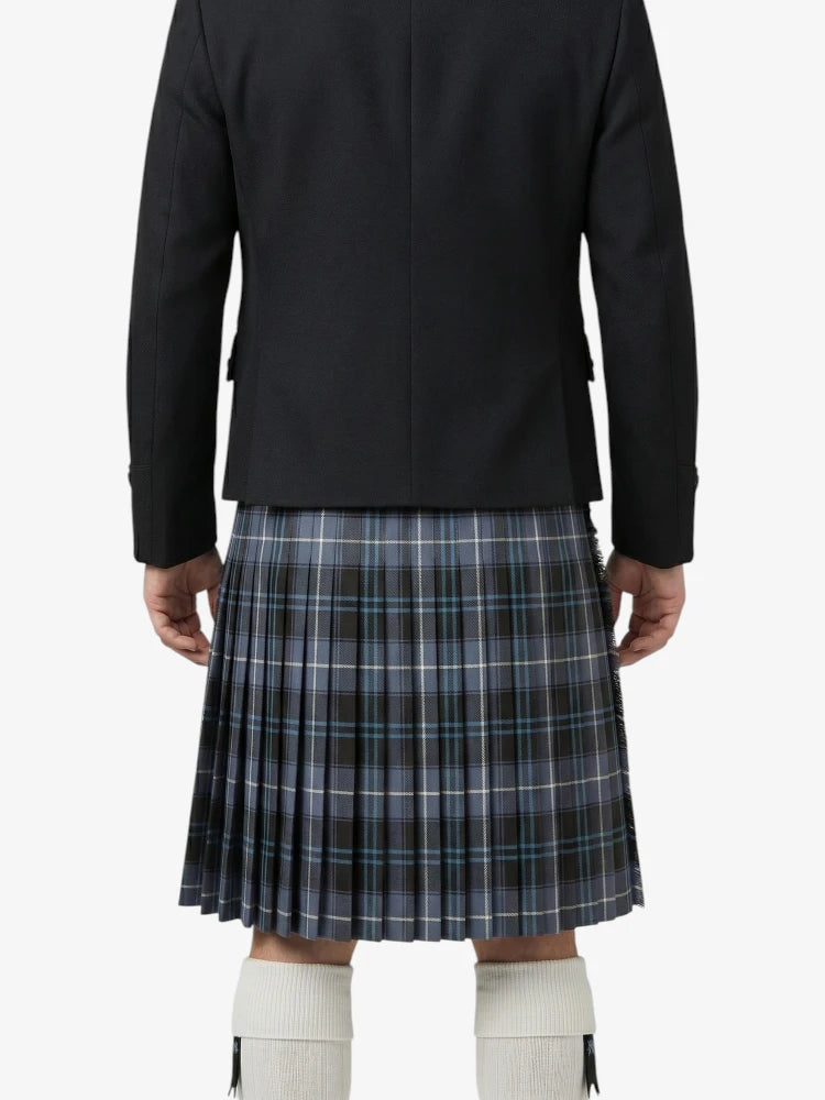 Person wearing a black jacket and plaid kilt on a white background