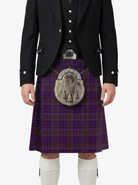 Person wearing a traditional Scottish kilt with a tartan pattern on a white background