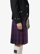 Person wearing a black jacket and purple plaid kilt on a white background