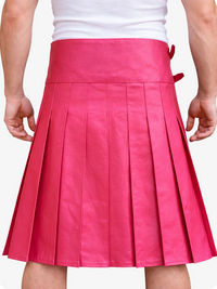 Pink pleated skirt worn by a person on a white background