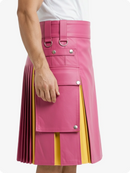 Pink kilt with yellow accents worn by a person on a white background