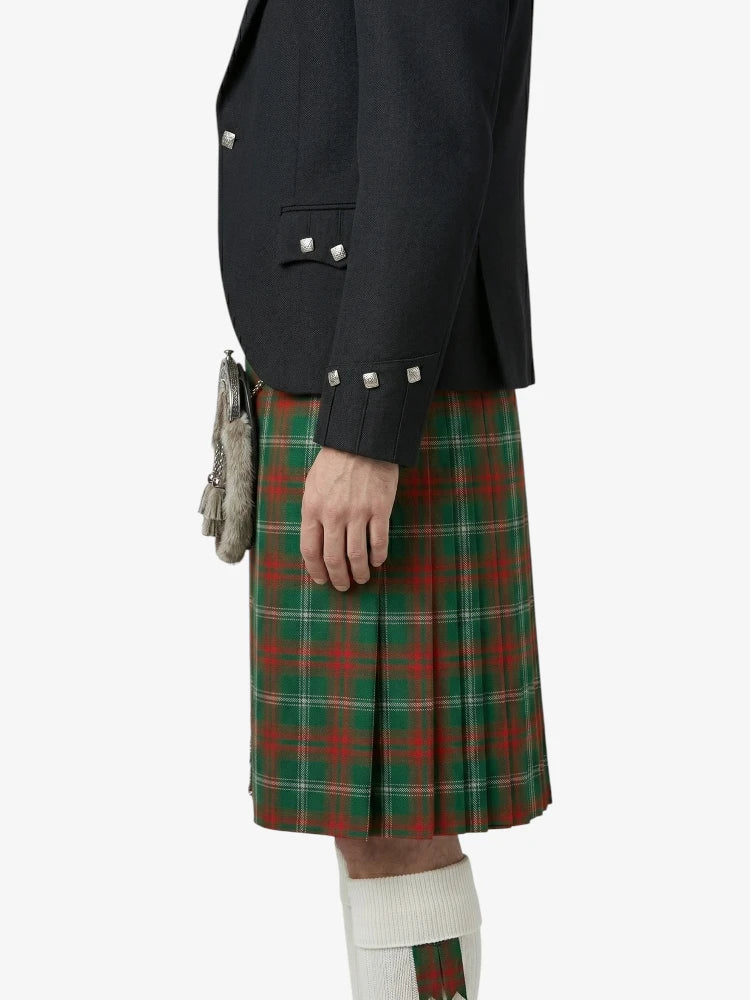 Person wearing a dark jacket and red plaid kilt on a white background