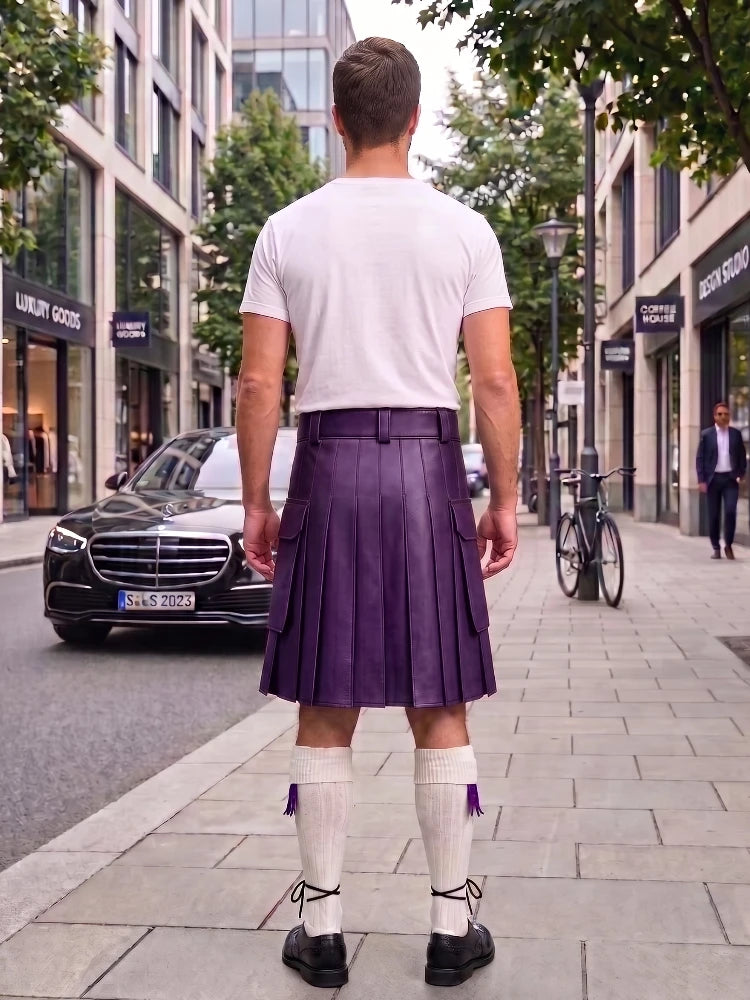 A man standing on a city sidewalk, viewed from behind, wearing a white t-shirt, a pleated purple kilt, white knee-high socks, and black shoes. Buildings, trees, a black Mercedes, and a bicycle are visible in the background.