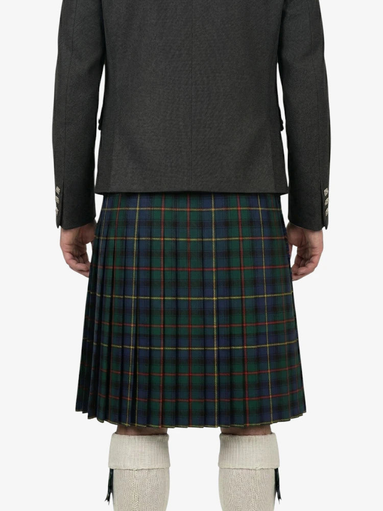Person wearing a dark gray jacket and green plaid kilt on a white background