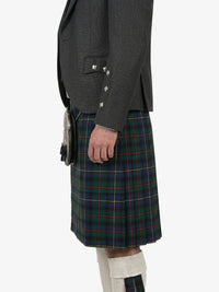 Person wearing a dark gray jacket and a plaid kilt on a white background