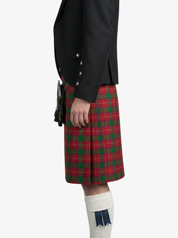 Person wearing a red plaid kilt with a black jacket on a white background