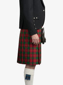 Person wearing a black jacket and red plaid kilt on a white background