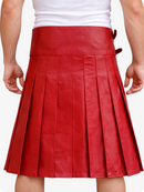 Red pleated leather skirt worn over a white top on a plain background