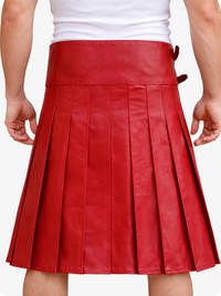 Red pleated leather skirt worn over a white top on a plain background